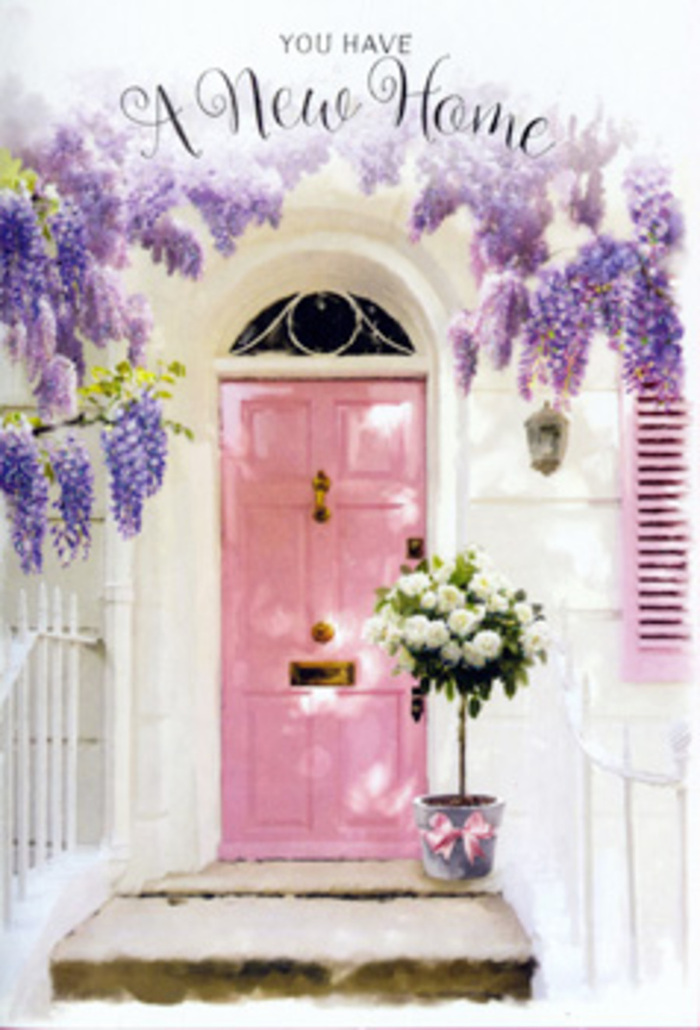 This tranquil doorway scene in Dalston captures the tender excitement of starting life in a new home. A softly painted pink door stands at the centre, its tone sitting somewhere between blush and rose, the kind of hue that feels both playful and reassuring. The door is bordered by whitewashed walls and a single pale shutter that seems to invite the light in, allowing the whole entrance to glow softly as if polished by the afternoon sun drifting over from the direction of Shacklewell Lane. Above, lush wisteria spills down in long, graceful strands, each stem laden with clusters of lavender blossoms. The flowers form loose, drooping garlands that almost touch the doorstep, their petals small and delicate yet abundant enough to create a romantic, scented canopy. At the foot of the door, set squarely on the stone step, sits a simple grey bucket that has been transformed into an elegant vessel for a luxurious arrangement of roses. The roses are creamy white with hints of butter and ivory, densely petalled and beautifully open, cushioned by soft green foliage that arcs naturally outward. A satin pink ribbon encircles the bucket, tied in a neat bow whose trailing ends rest against the cool stone, adding a gentle flourish that ties every colour together. The interplay of light and shadow across the doorway lends a quiet intimacy, as if this is a private, cherished moment caught between unpacked boxes and first cups of tea. The composition conveys reassurance, hope, and warmth, like a housewarming floral gift waiting at a Dalston doorstep, ready to greet its new owners with softness, beauty, and the unspoken message: this place is home now.